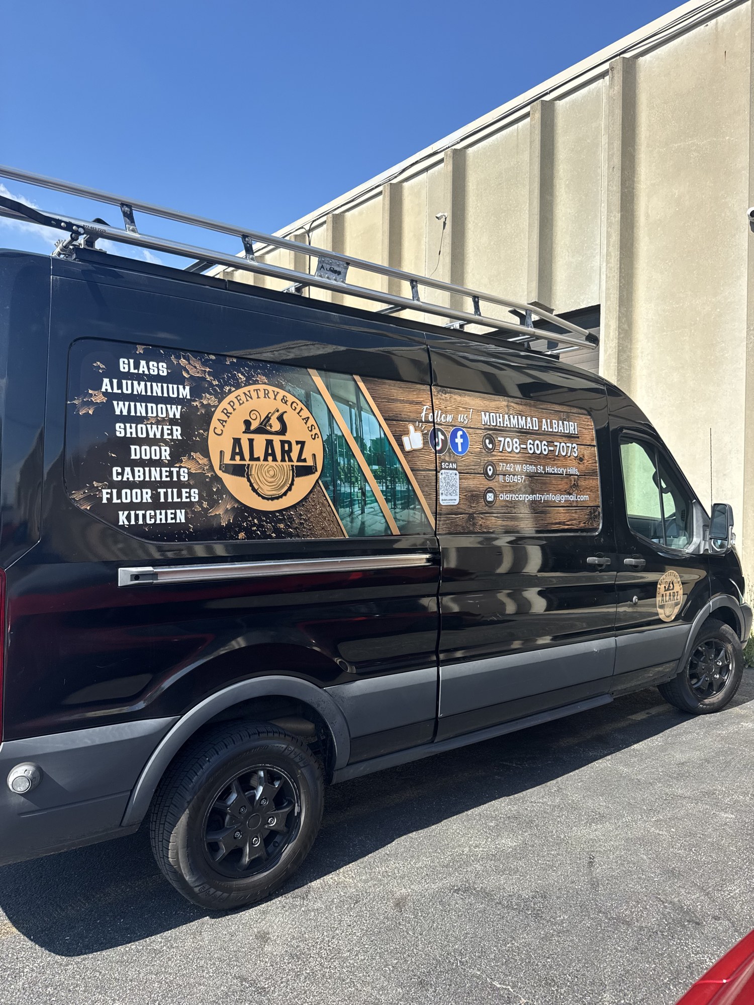 Alarz Carpentry & Glass wrapped work van outside the Hickory Hills shop